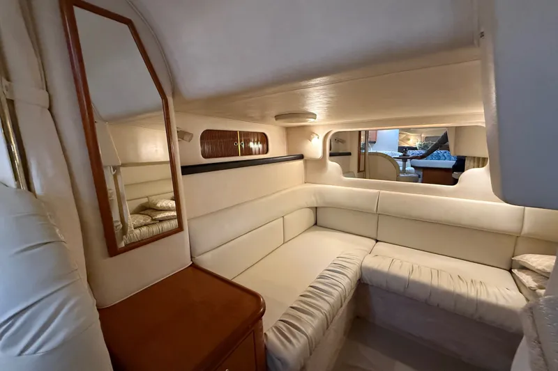 Slide: The Image of Luxurious interior of 2000 Sea Ray 340 Sundancer yacht with cream seating and wood accents. - 51
