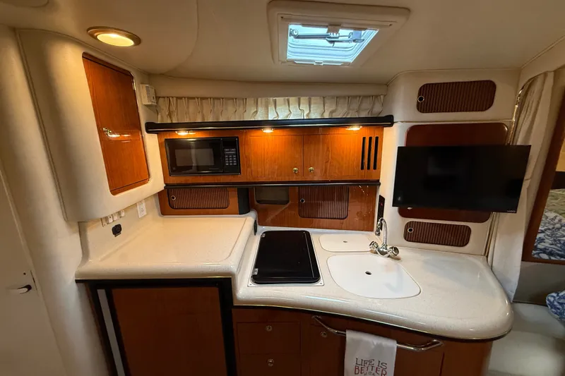 Slide: The Image of Interior of 2000 Sea Ray 340 Sundancer yacht with kitchenette, microwave, and TV. - 36
