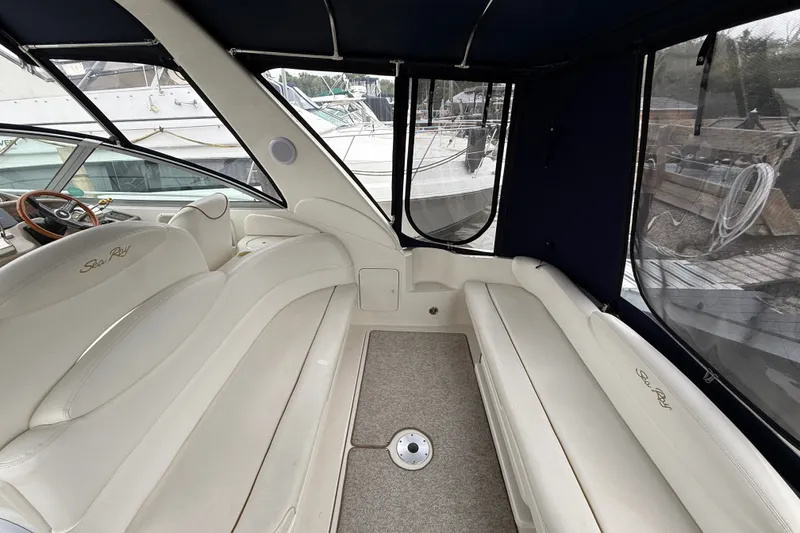 Slide: The Image of Interior of 2000 Sea Ray 340 Sundancer boat with white seating and enclosed cockpit. - 8