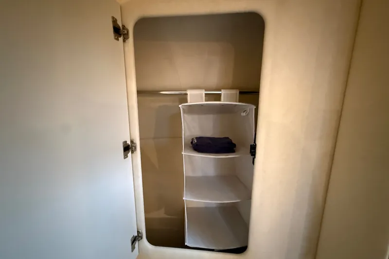 Slide: The Image of Open closet with shelves inside a 2000 Sea Ray 340 Sundancer boat. - 47