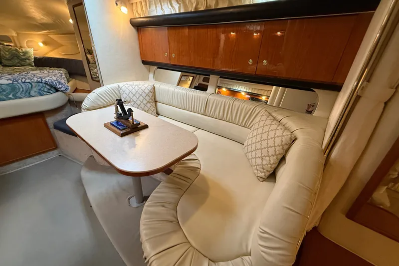 Slide: The Image of Interior of 2000 Sea Ray 340 Sundancer with cozy seating and elegant wood cabinetry. - 34