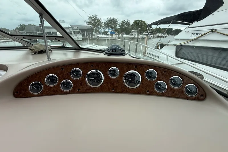 Slide: The Image of Dashboard of a 2000 Sea Ray 340 Sundancer boat with gauges and compass. - 24