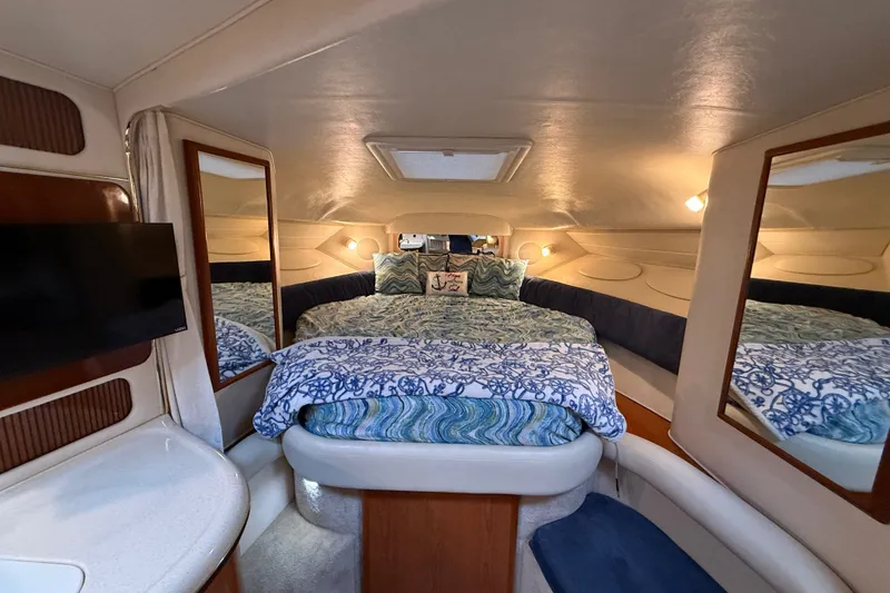 Slide: The Image of Luxurious interior of 2000 Sea Ray 340 Sundancer with cozy bedding and elegant decor. - 43