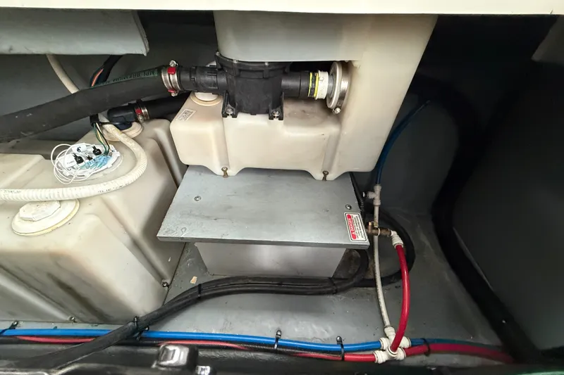 Slide: The Image of Engine compartment of a 2000 Sea Ray 340 Sundancer boat, showing hoses and components. - 65