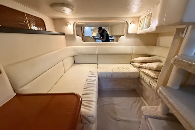 Slide: The Image of Interior of 2000 Sea Ray 340 Sundancer yacht with beige seating and wooden table. - 52