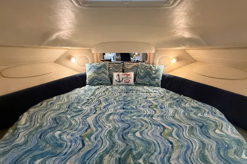 Slide: The Image of Cozy cabin interior of 2000 Sea Ray 340 Sundancer with nautical-themed bedding. - 46