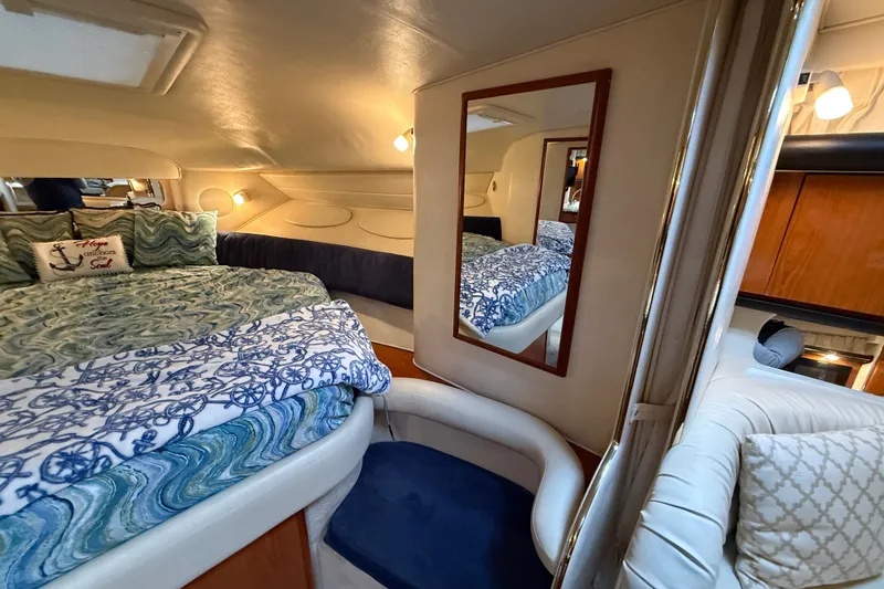 Slide: The Image of Luxurious interior of 2000 Sea Ray 340 Sundancer yacht with cozy bedding and elegant decor. - 44