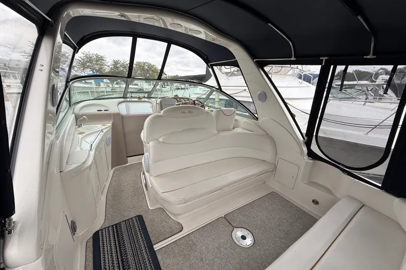 Slide: The Image of Interior of a 2000 Sea Ray 340 Sundancer boat with white seating and helm. - 7