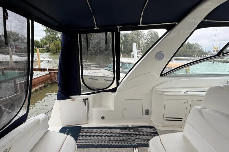 Slide: The Image of Interior view of a 2000 Sea Ray 340 Sundancer boat docked by the water. - 15