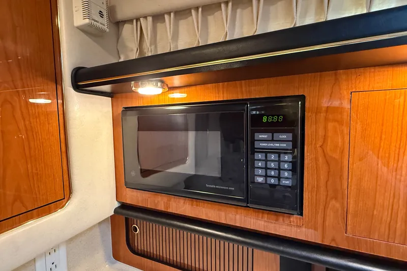 Slide: The Image of Microwave in 2000 Sea Ray 340 Sundancer yacht interior, featuring wood cabinetry. - 41