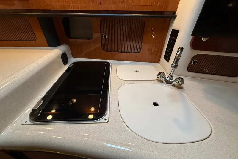 Slide: The Image of 2000 Sea Ray 340 Sundancer kitchen area with stove and sink. - 37