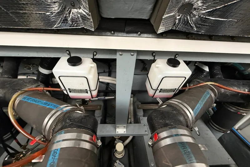 Slide: The Image of Engine compartment of a 2000 Sea Ray 340 Sundancer with visible hoses and components. - 60