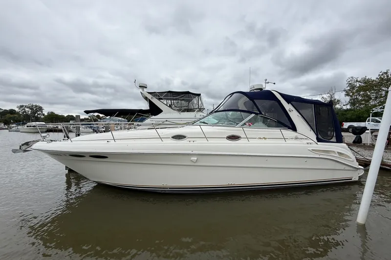 Slide: The Image of 2000 Sea Ray 340 Sundancer boat docked on a cloudy day. - 1