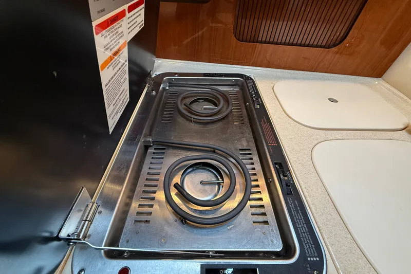 Slide: The Image of Stovetop in 2000 Sea Ray 340 Sundancer yacht kitchen, featuring dual electric burners. - 38