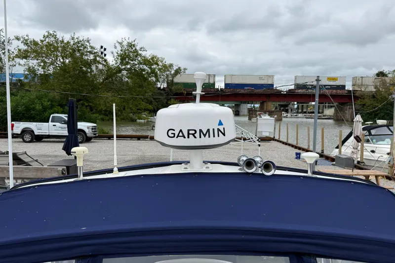 Slide: The Image of 2000 Sea Ray 340 Sundancer with Garmin radar, docked near a bridge on a cloudy day. - 4