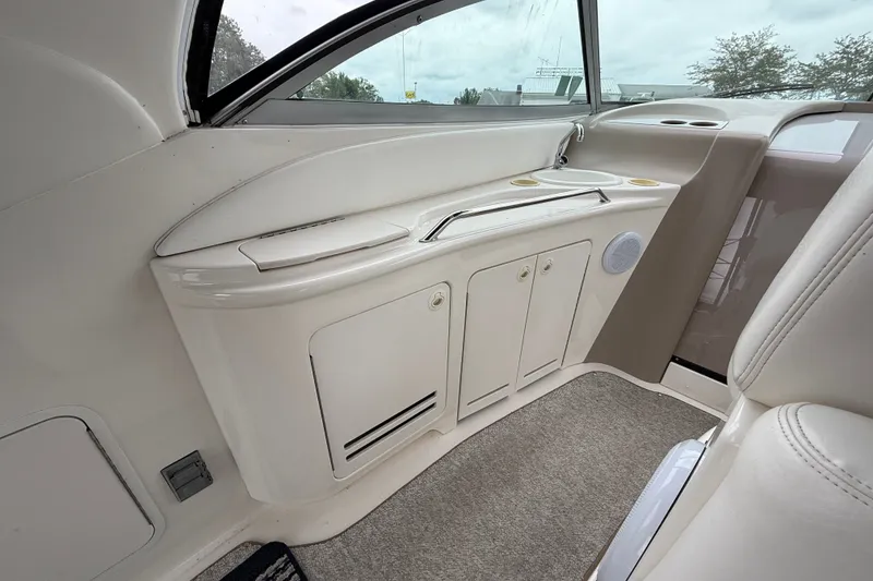 Slide: The Image of Interior view of a 2000 Sea Ray 340 Sundancer boat, featuring a sleek kitchenette area. - 17