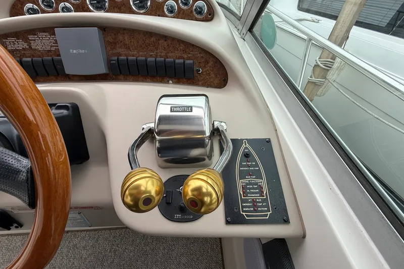Slide: The Image of Control panel of a 2000 Sea Ray 340 Sundancer boat with throttle and steering wheel. - 27