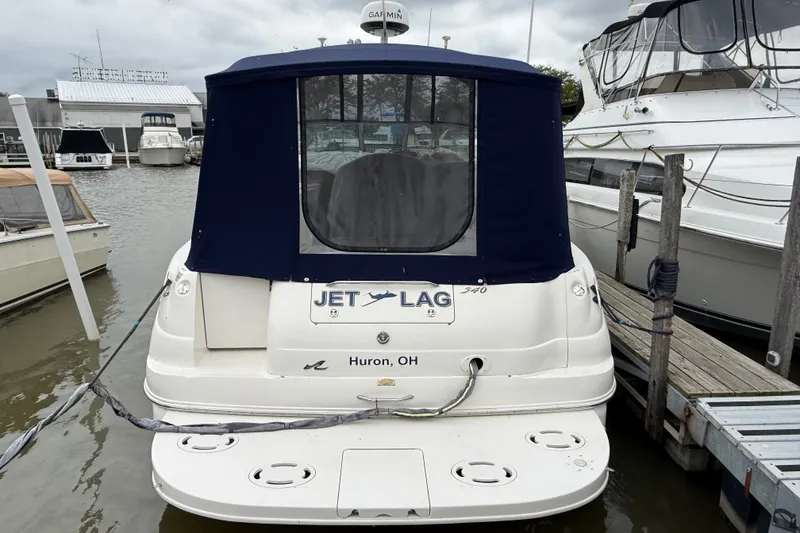 Slide: The Image of 2000 Sea Ray 340 Sundancer docked, featuring "Jet Lag" name and Huron, OH location. - 2