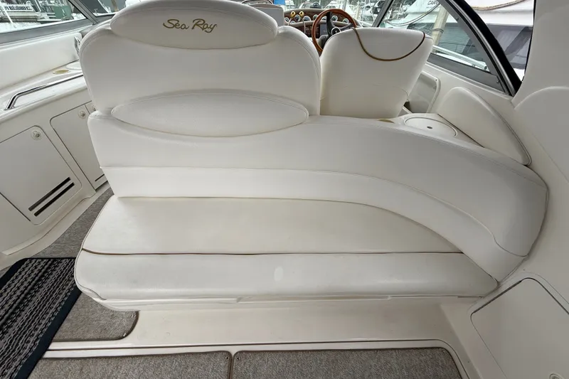 Slide: The Image of Interior seating of a 2000 Sea Ray 340 Sundancer boat, featuring white upholstery. - 12