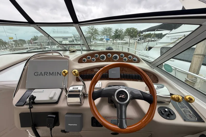 Slide: The Image of Cockpit of 2000 Sea Ray 340 Sundancer with Garmin navigation system and wooden steering wheel. - 23
