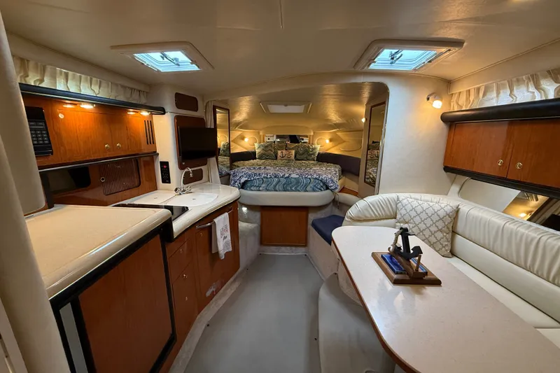 Slide: The Image of Luxurious interior of a 2000 Sea Ray 340 Sundancer yacht with cozy seating and kitchenette. - 32