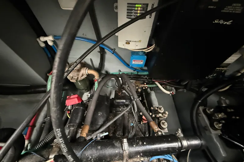 Slide: The Image of Engine compartment of a 2000 Sea Ray 340 Sundancer with visible wiring and components. - 67