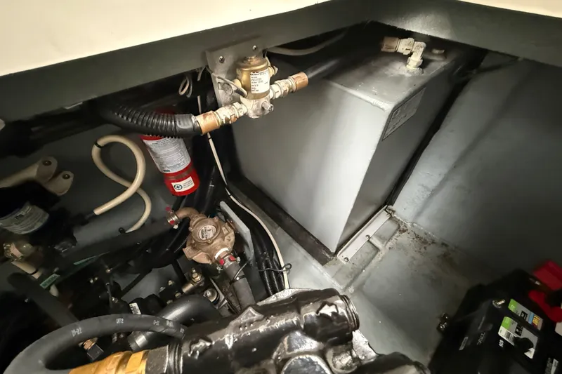 Slide: The Image of Engine compartment of a 2000 Sea Ray 340 Sundancer, showing mechanical components and wiring. - 62