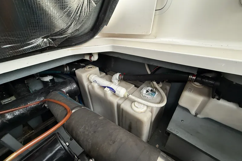 Slide: The Image of Engine compartment of a 2000 Sea Ray 340 Sundancer, showing water tanks and hoses. - 66