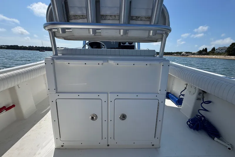 Slide: The Image of 2006 Regulator 26 Forward Seating boat interior with storage compartments, on a sunny day. - 5