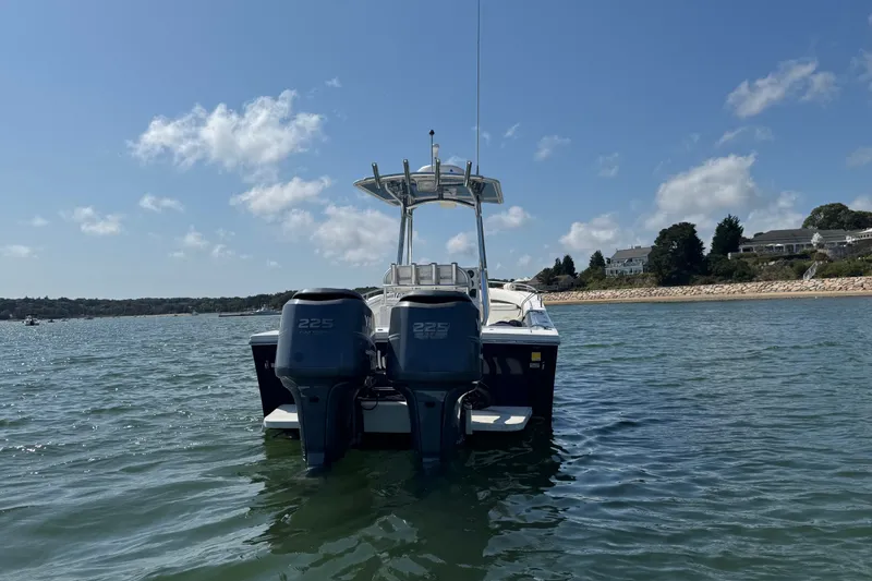 Slide: The Image of 2006 Regulator 26 Forward Seating boat on water with twin 225 engines. - 1