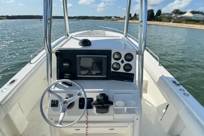 Slide: The Image of 2006 Regulator 26 Forward Seating boat dashboard with steering wheel and navigation instruments. - 4