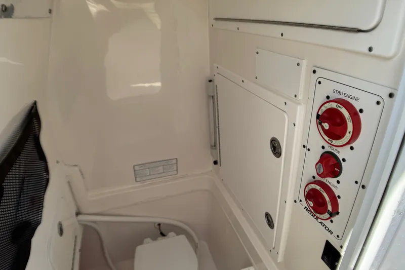 Slide: The Image of 2006 Regulator 26 Forward Seating boat interior with control panel and storage compartment. - 10