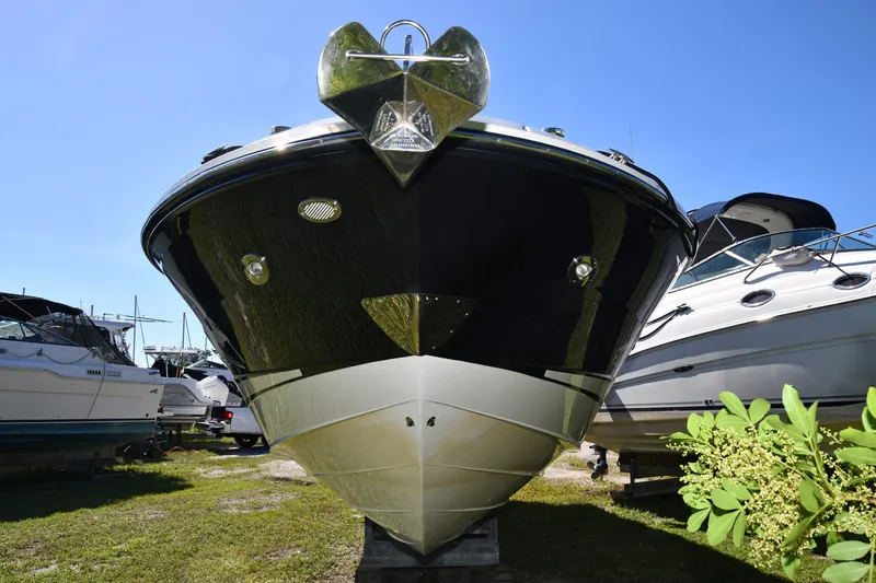 Slide: The Image of 2017 Sea Ray SLX 310 boat on display, front view, surrounded by other boats. - 13