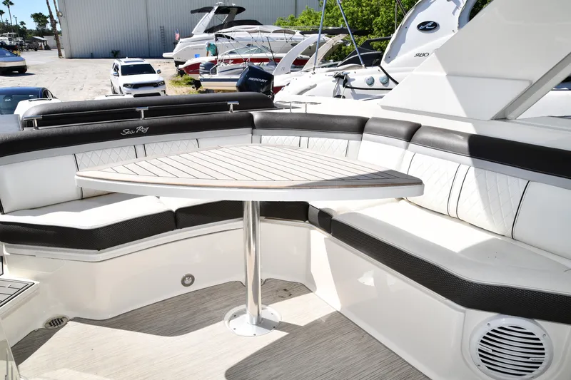 Slide: The Image of 2017 Sea Ray SLX 310 boat interior with elegant seating and a stylish table. - 33