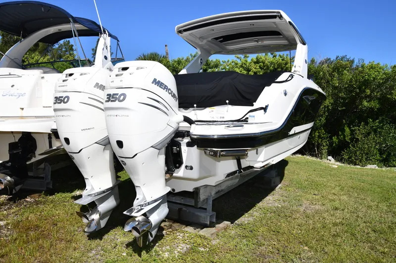 Slide: The Image of 2017 Sea Ray SLX 310 boat with twin Mercury 350 engines on display outdoors. - 8