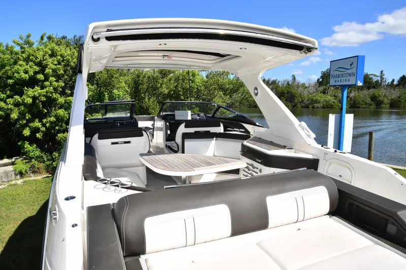 Slide: The Image of 2017 Sea Ray SLX 310 boat interior at Harbortown Marina, featuring seating and table. - 37