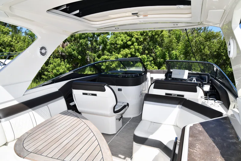 Slide: The Image of Luxurious 2017 Sea Ray SLX 310 boat interior with sleek seating and modern dashboard. - 6