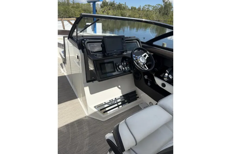Slide: The Image of Cockpit of 2017 Sea Ray SLX 310 boat with steering wheel and control panel. - 1