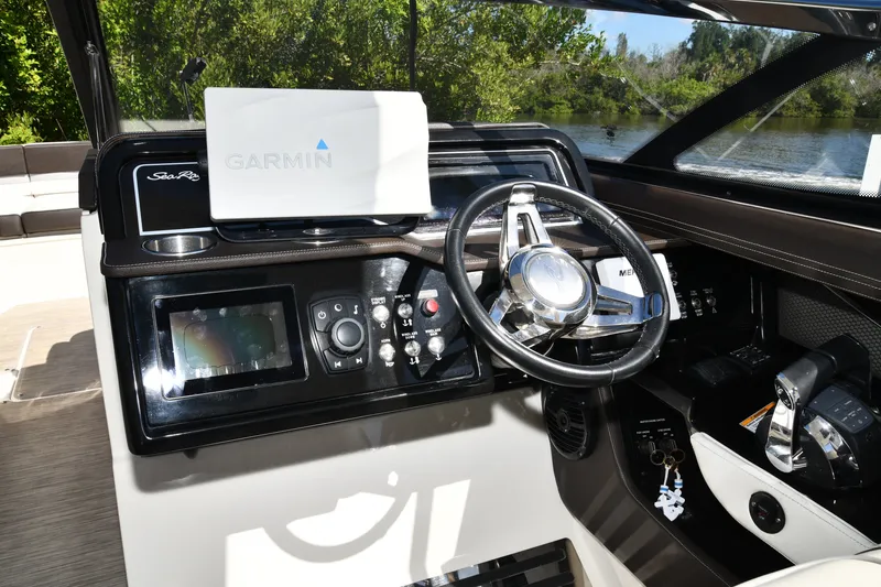 Slide: The Image of Cockpit of 2017 Sea Ray SLX 310 with Garmin navigation system and steering wheel. - 4