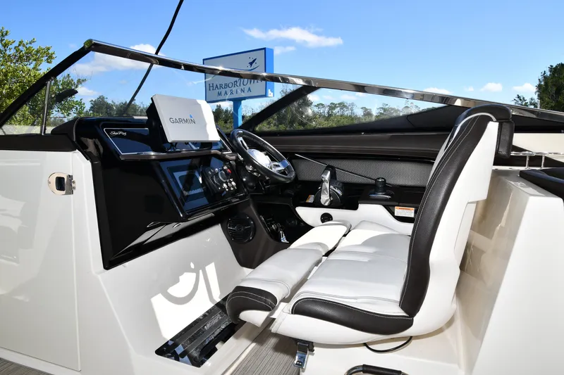 Slide: The Image of 2017 Sea Ray SLX 310 boat cockpit with Garmin navigation, sleek design, and comfortable seating. - 28