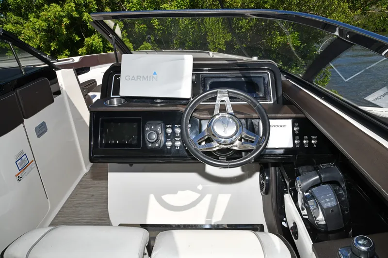 Slide: The Image of 2017 Sea Ray SLX 310 helm with Garmin navigation and modern controls. - 43