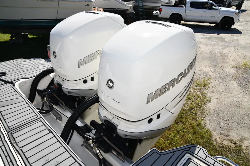 Slide: The Image of Twin Mercury outboard engines on a 2017 Sea Ray SLX 310 boat. - 17