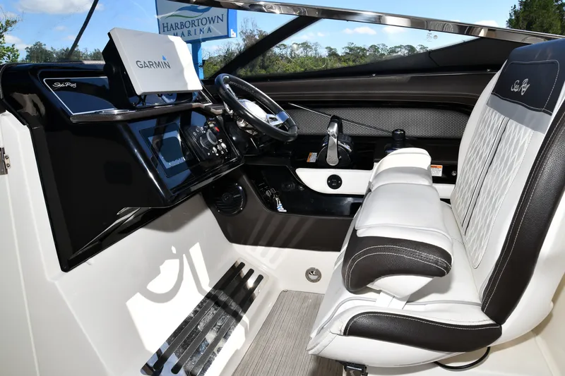 Slide: The Image of 2017 Sea Ray SLX 310 boat cockpit with Garmin navigation system and luxurious seating. - 25