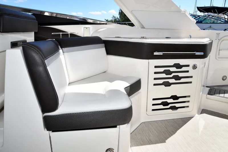 Slide: The Image of Luxurious seating area on a 2017 Sea Ray SLX 310 boat, featuring sleek black and white upholstery. - 34