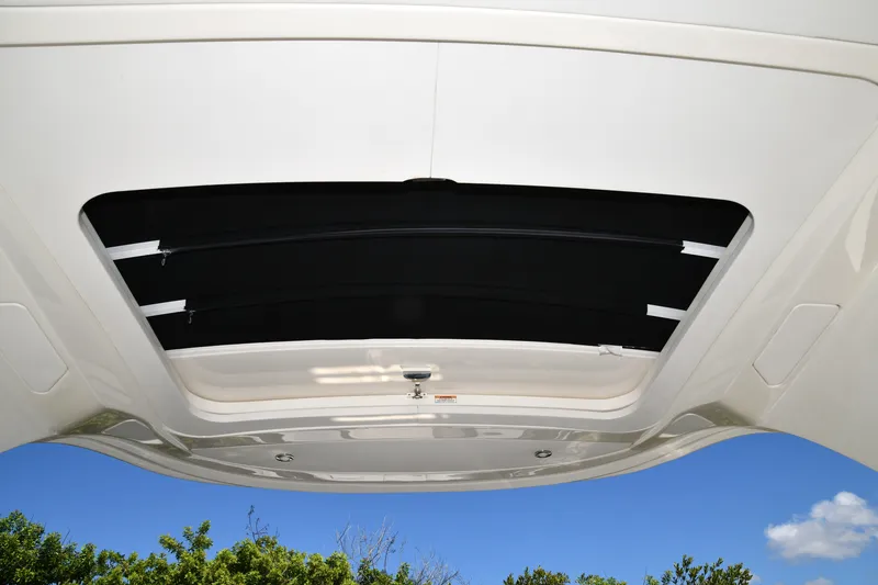 Slide: The Image of 2017 Sea Ray SLX 310 boat sunroof with clear blue sky background. - 41