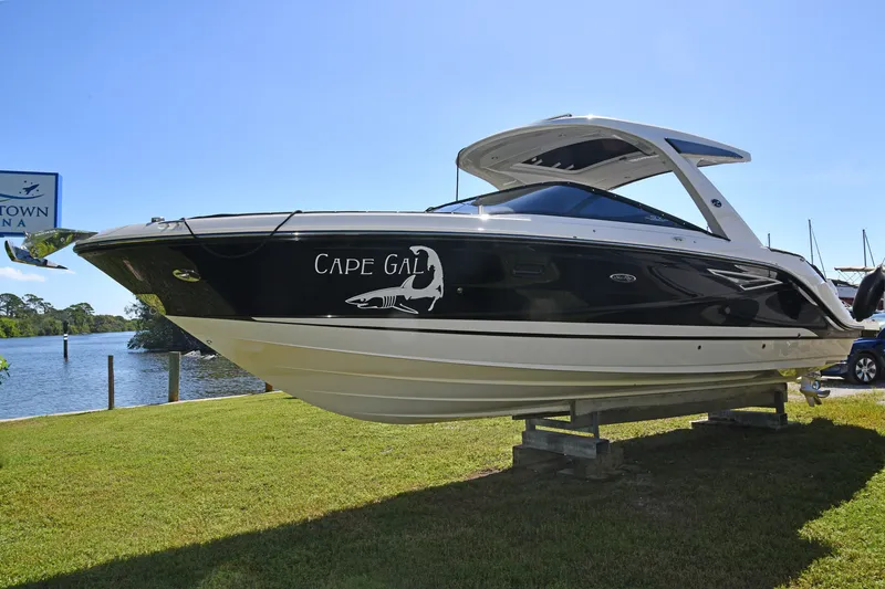 Slide: The Image of 2017 Sea Ray SLX 310 boat on display at a marina, sunny day. - 2