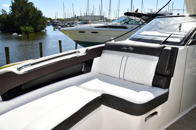 Slide: The Image of 2017 Sea Ray SLX 310 boat interior with luxurious seating at marina. - 12