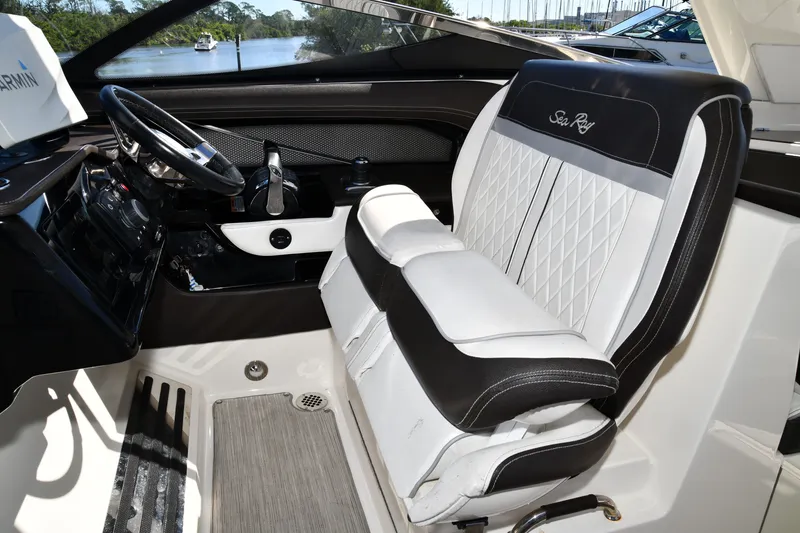 Slide: The Image of 2017 Sea Ray SLX 310 cockpit with luxurious seating and modern controls. - 11
