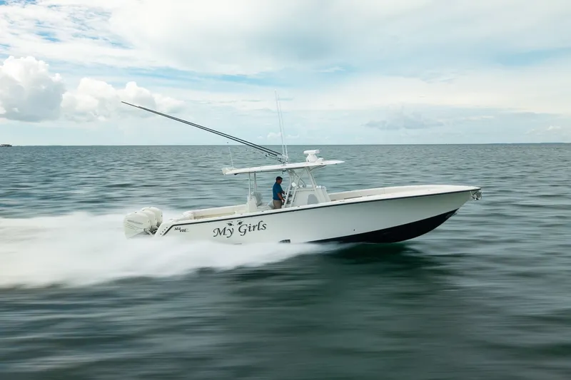 Slide: The Image of 2017 SeaVee 390Z boat speeding on open water under a cloudy sky. - 14