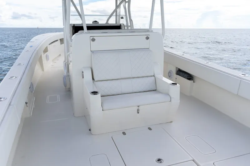 Slide: The Image of 2017 SeaVee 390Z boat interior with white seating, ocean view in background. - 43